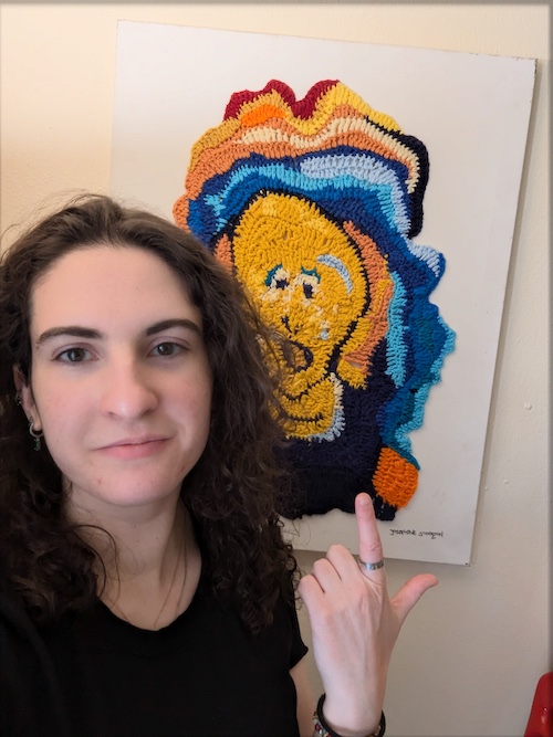 Josephine Stockton standing with her Scream fiber artwork