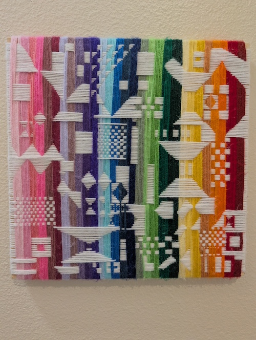 A colorful abstract woven fiber work